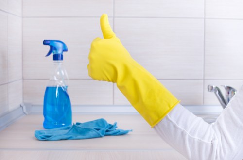 Local cleaner vacuuming fine construction dust in a Putney property
